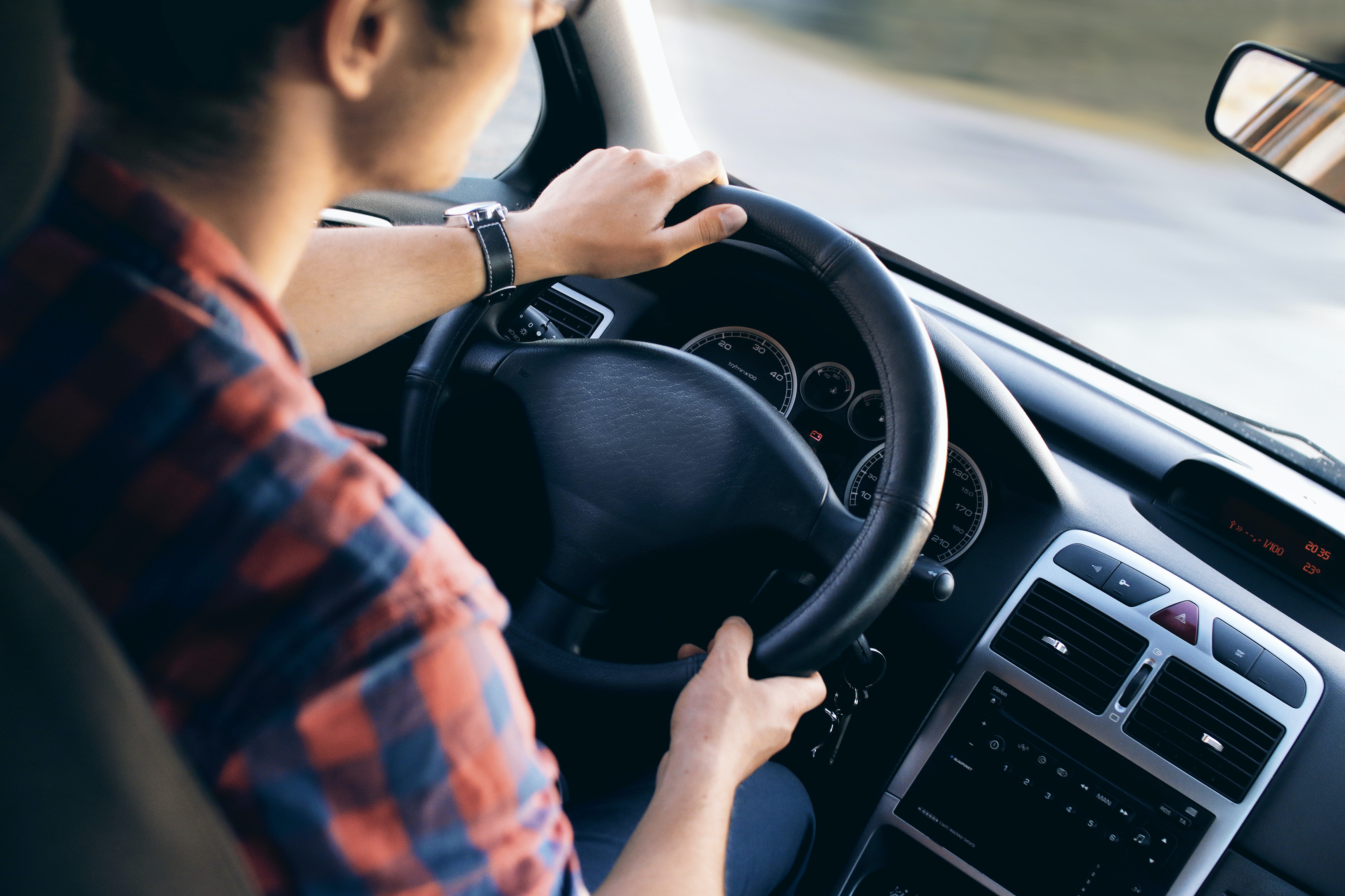 Man Holding Steering Wheel